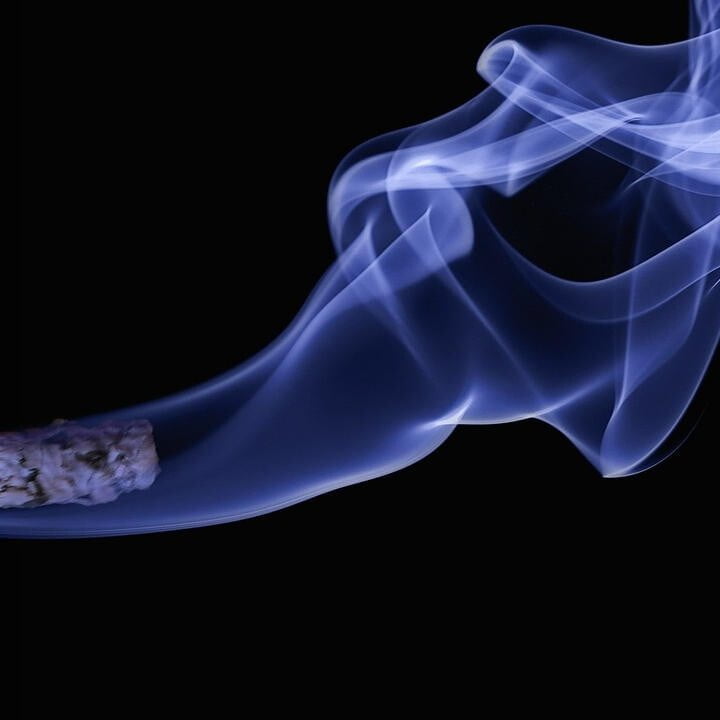 A burning cigarette with smoke